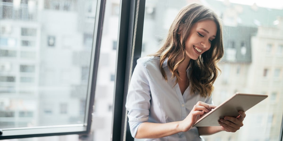 professional woman in office holding tablet