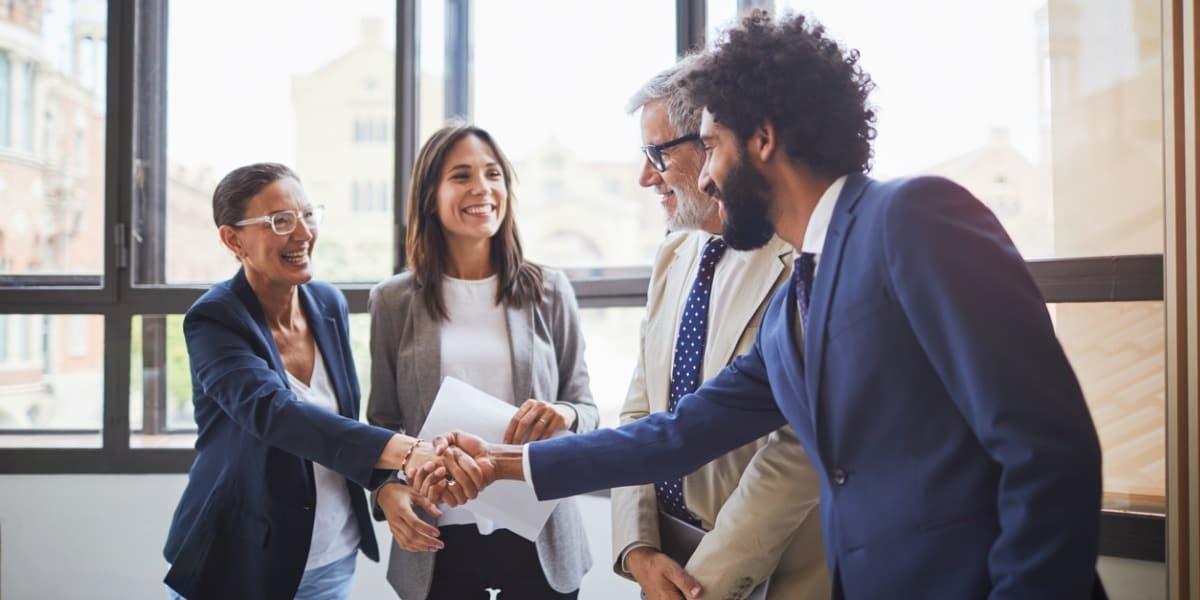 group of people shaking hands and smiling