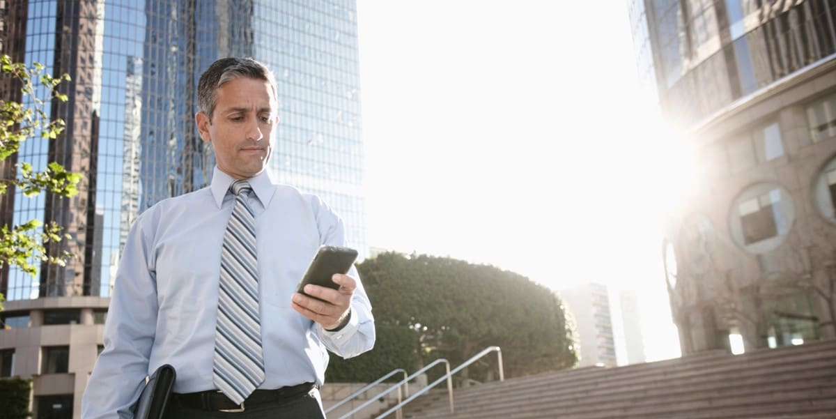 man outside with phone