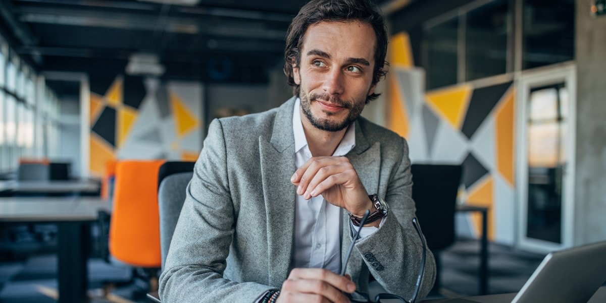 man in office, smiling