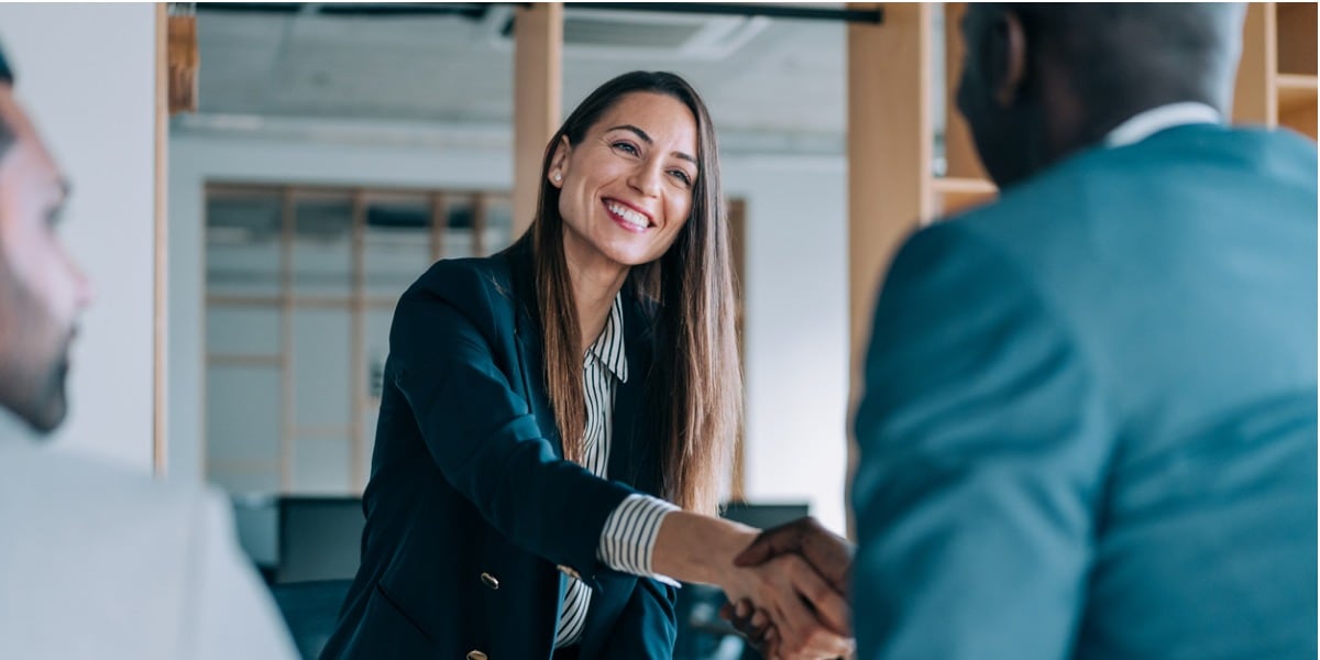 business woman shaking someone's hand