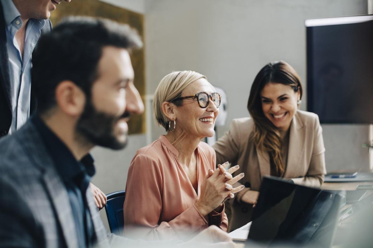 three people in a meeting room 