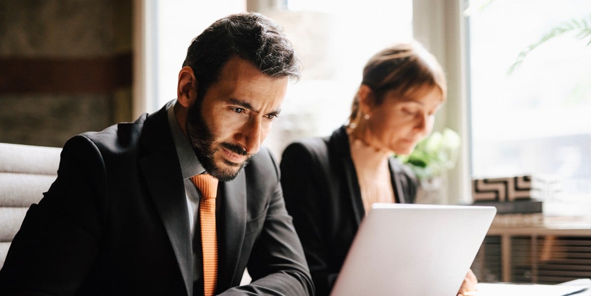 two professionals in the office working at a desk
