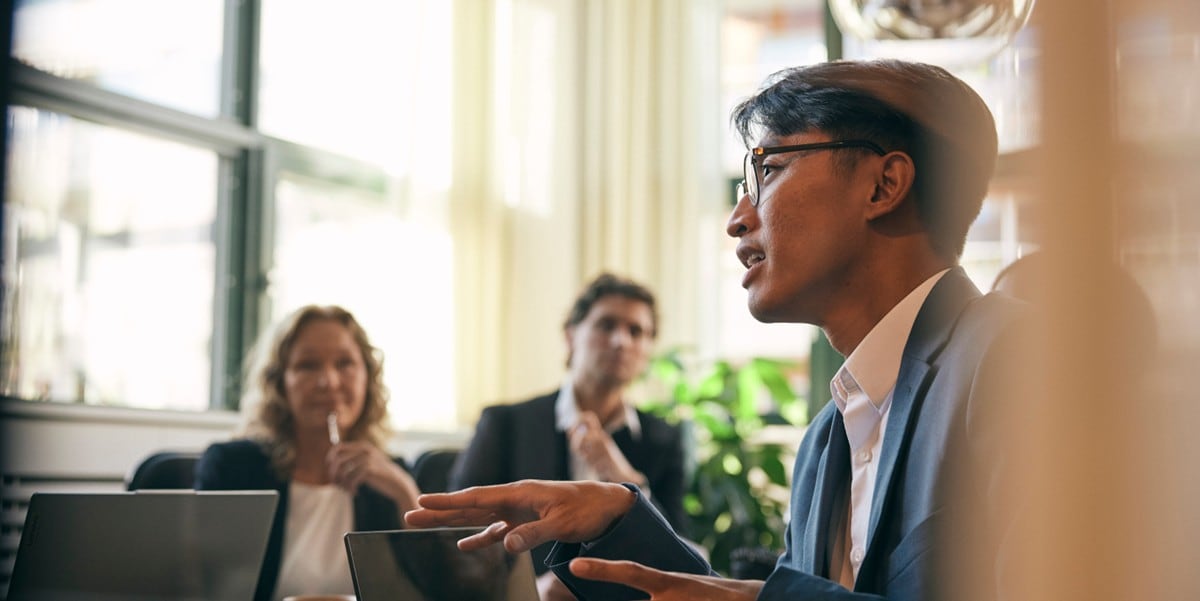 3 professionals in the office in a discussion
