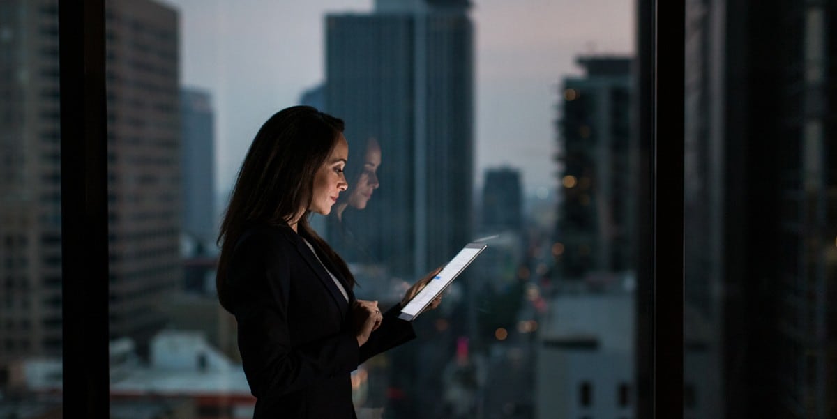 professional woman in the office looking at tablet