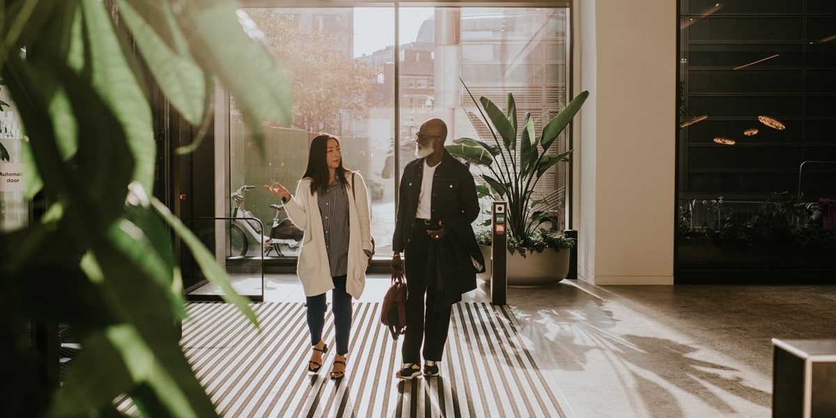 two professionals in an office lobby