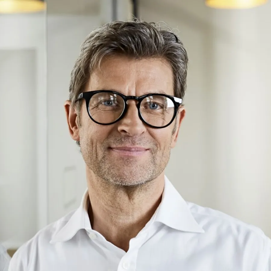 professional man smiling, in office